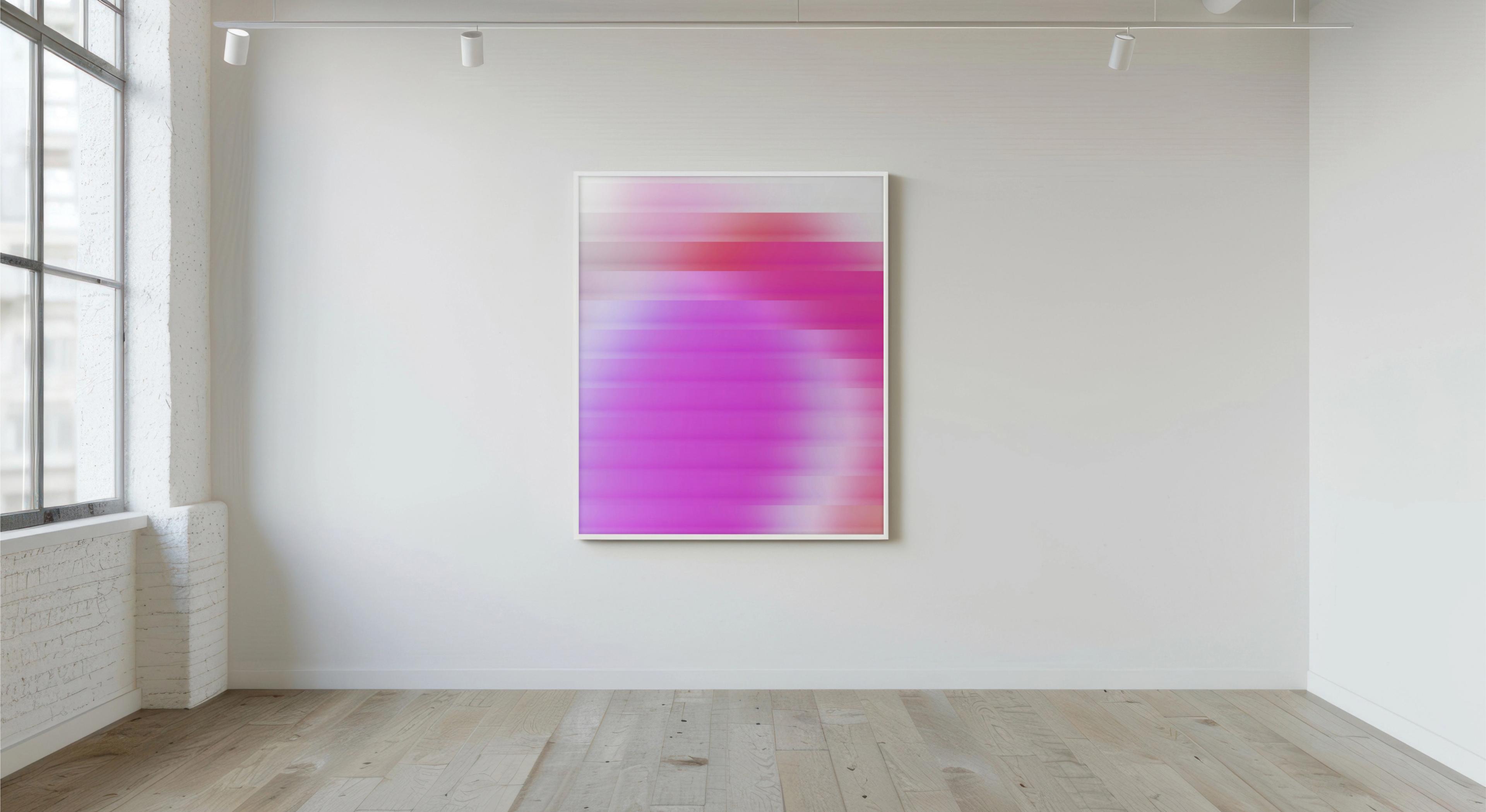 Gallery interior with a framed magenta abstract painting on a white wall, wood floor and track lighting